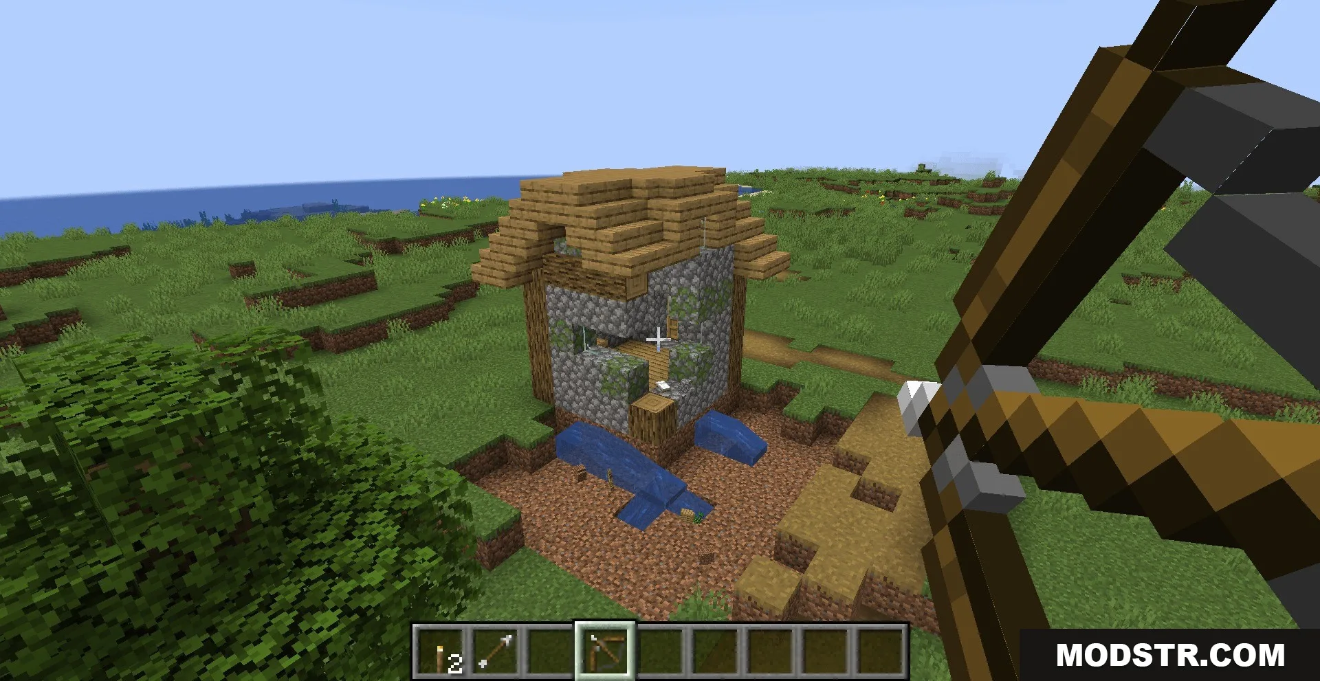 Shatterbolt Artillery Data Pack Screenshot 2 Player aiming a bow at a house using Shatterbolt Artillery data pack