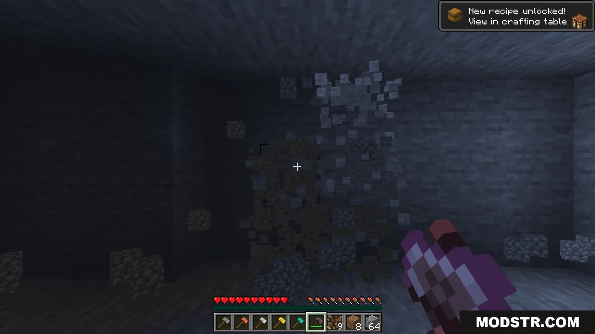 Mining a three by three area of stone blocks in a dark cave