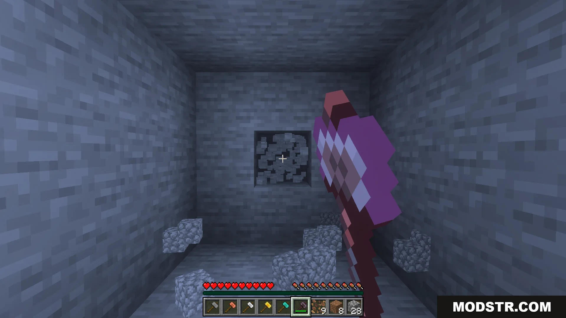 Player holding a new hammer tool facing a stone wall in cave