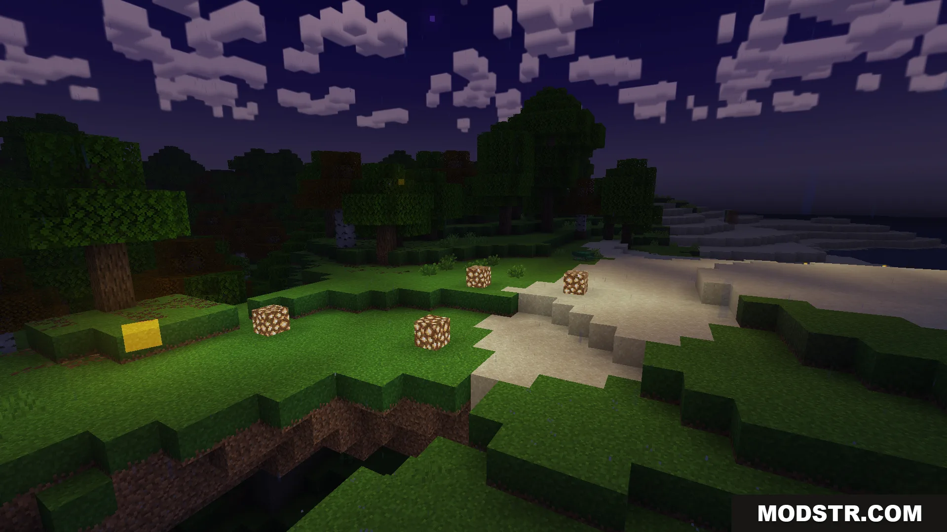 Glowing blocks placed on grass near sand in Minecraft