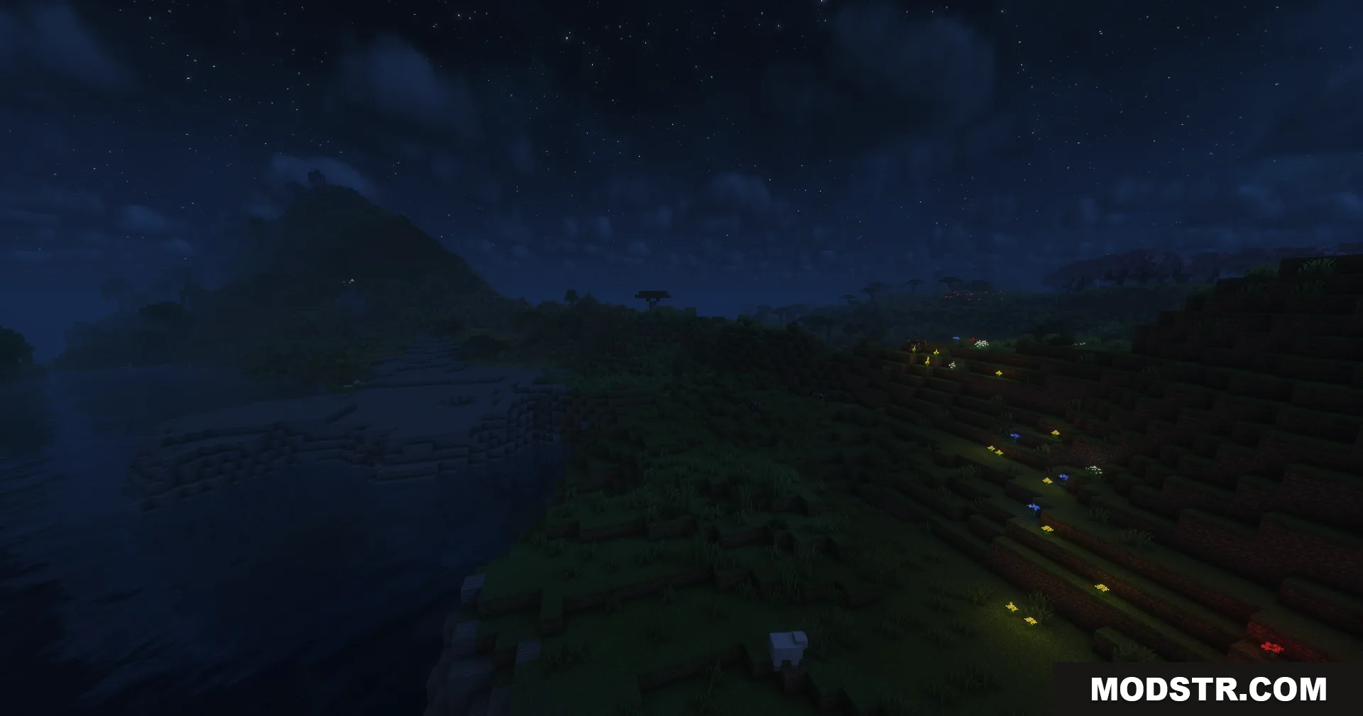 Glowing flowers on a dark hillside next to a river in Minecraft