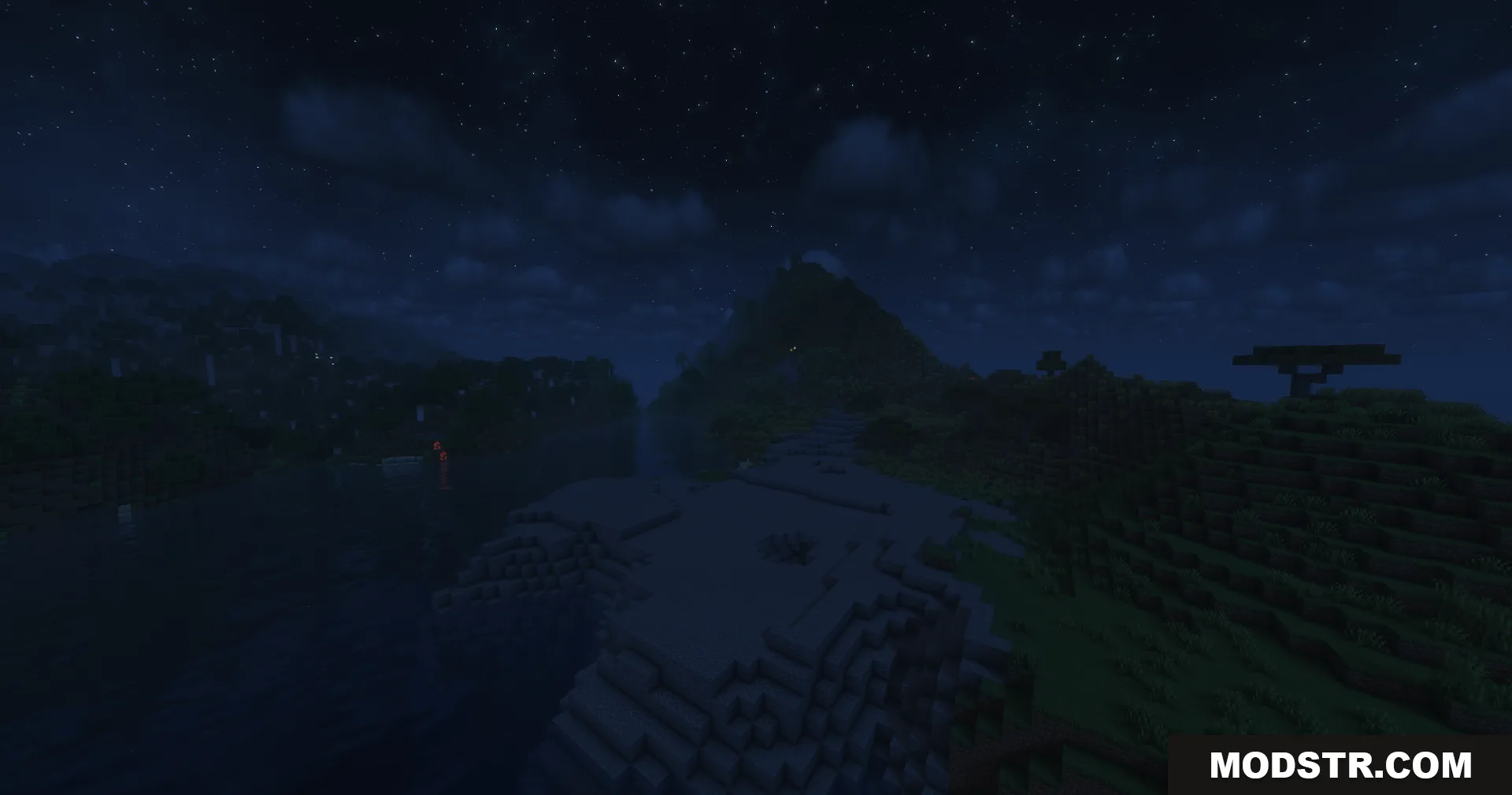 Soft moonlight reflects off a river surrounded by dark mountains and trees