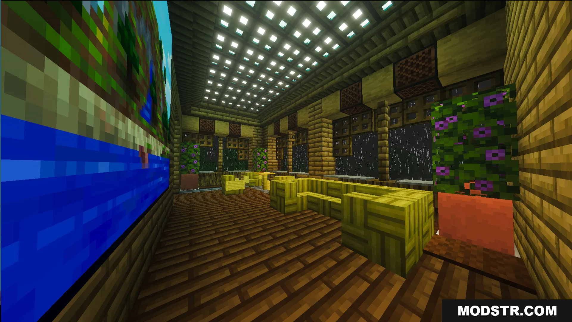 Interior of Survival Filo House with yellow furniture and a large wall painting