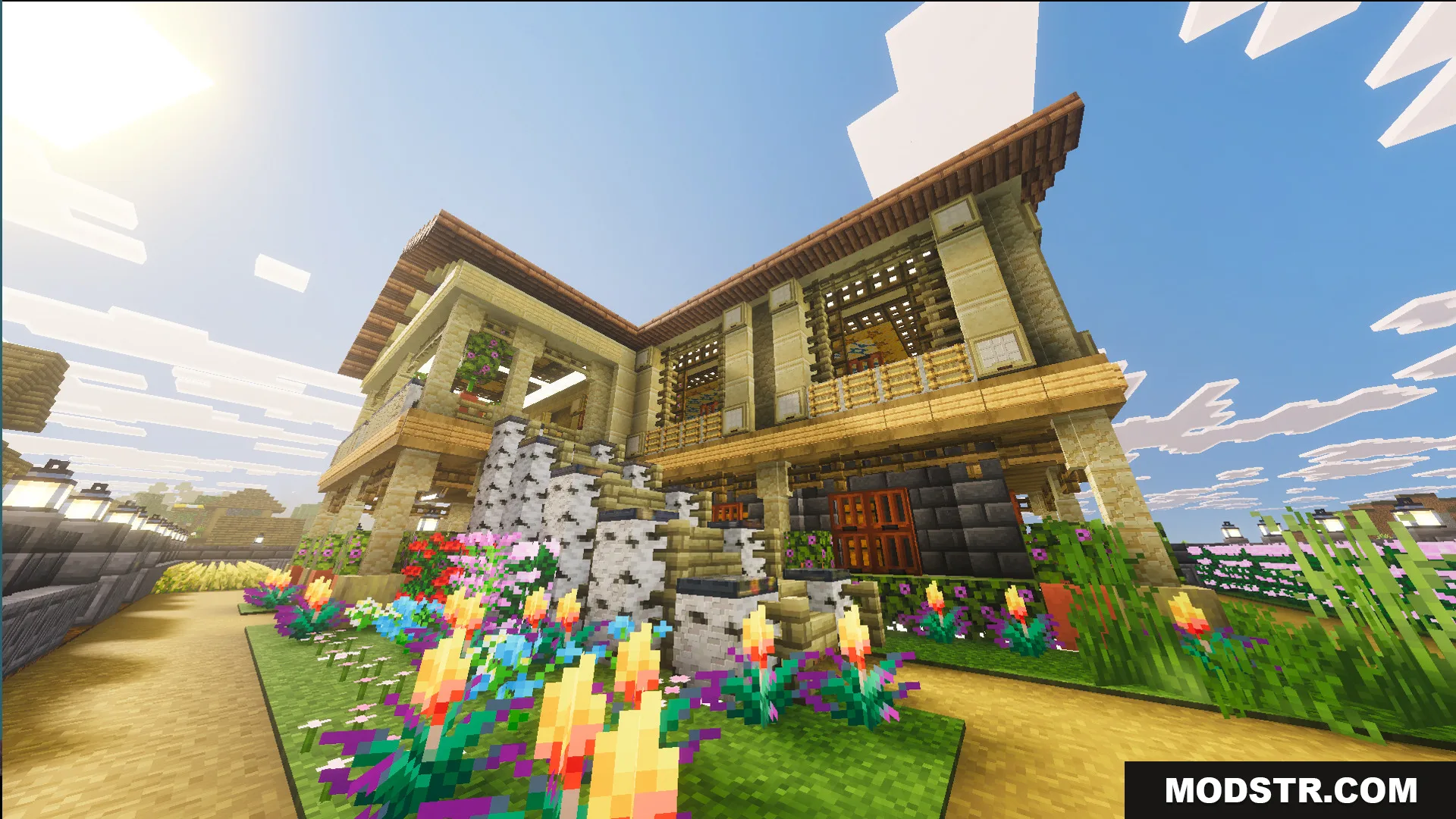 A side view of the mansion with colorful flowers and birch stairs