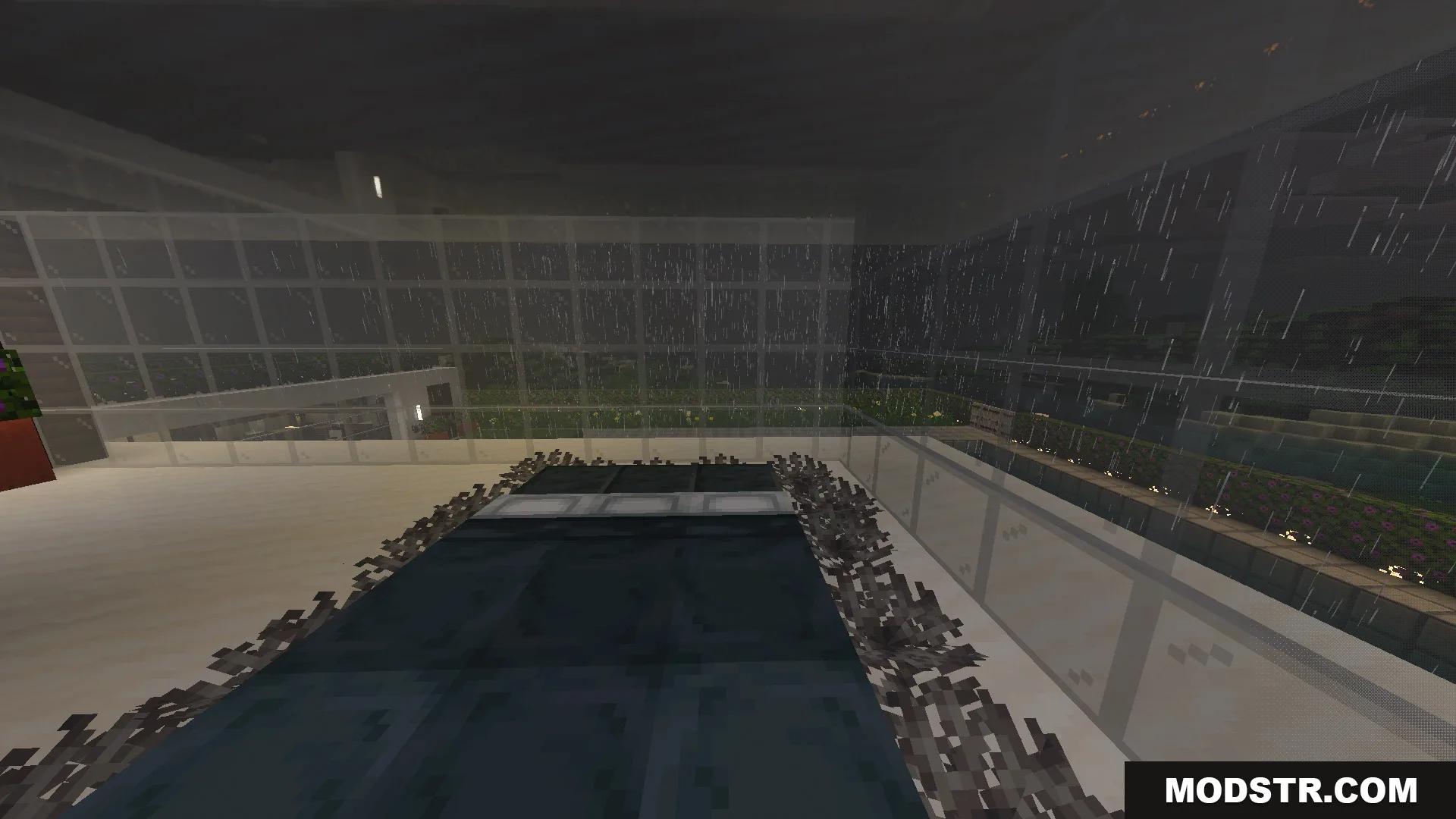 Modern interior room with dark flooring and glass walls during a rainy night