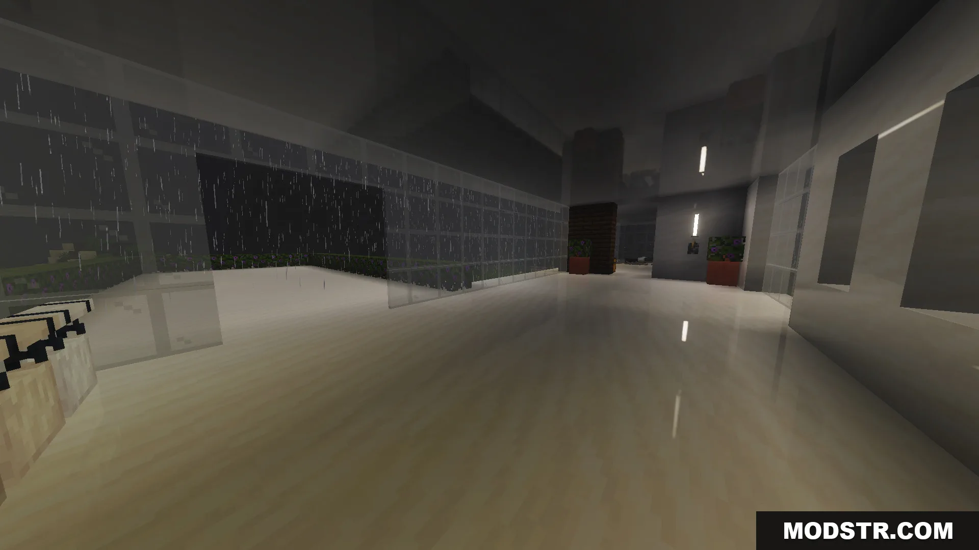 Interior view of a modern house featuring white floors and large glass windows