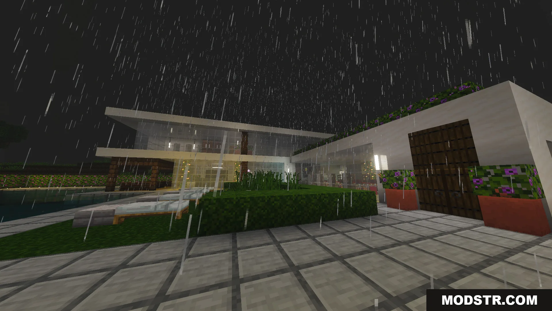 Exterior view of a modern white house with large glass windows during rain