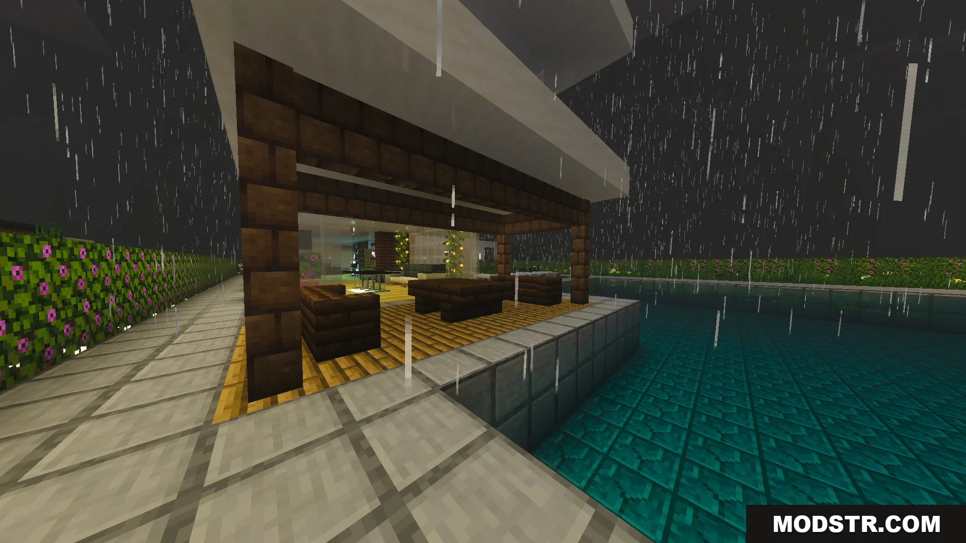 Modern outdoor seating area next to a swimming pool in the rain
