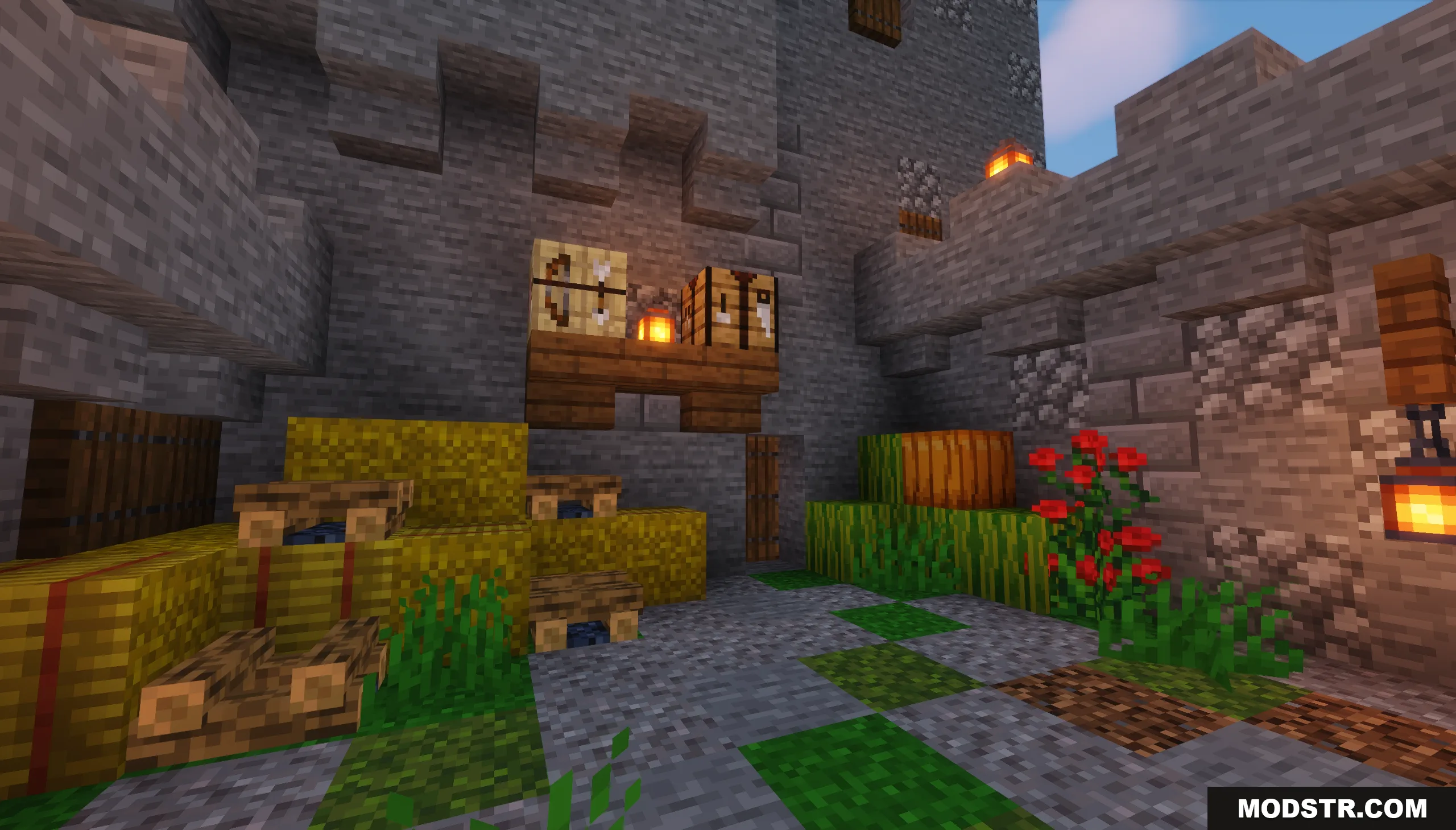 A castle courtyard with hay bales fletching table and crafting table