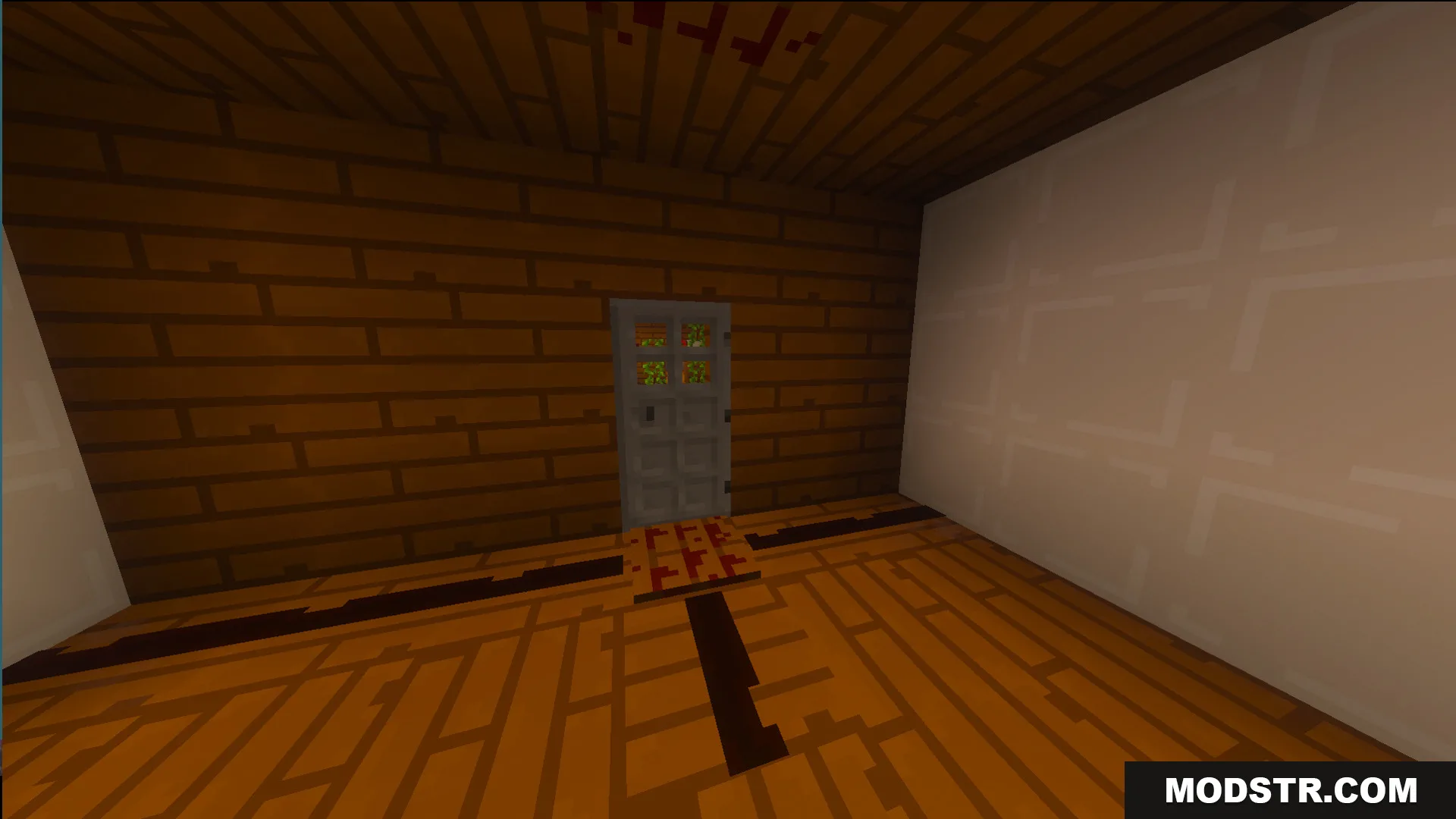 Wooden room with a gray door and a white wall inside a house