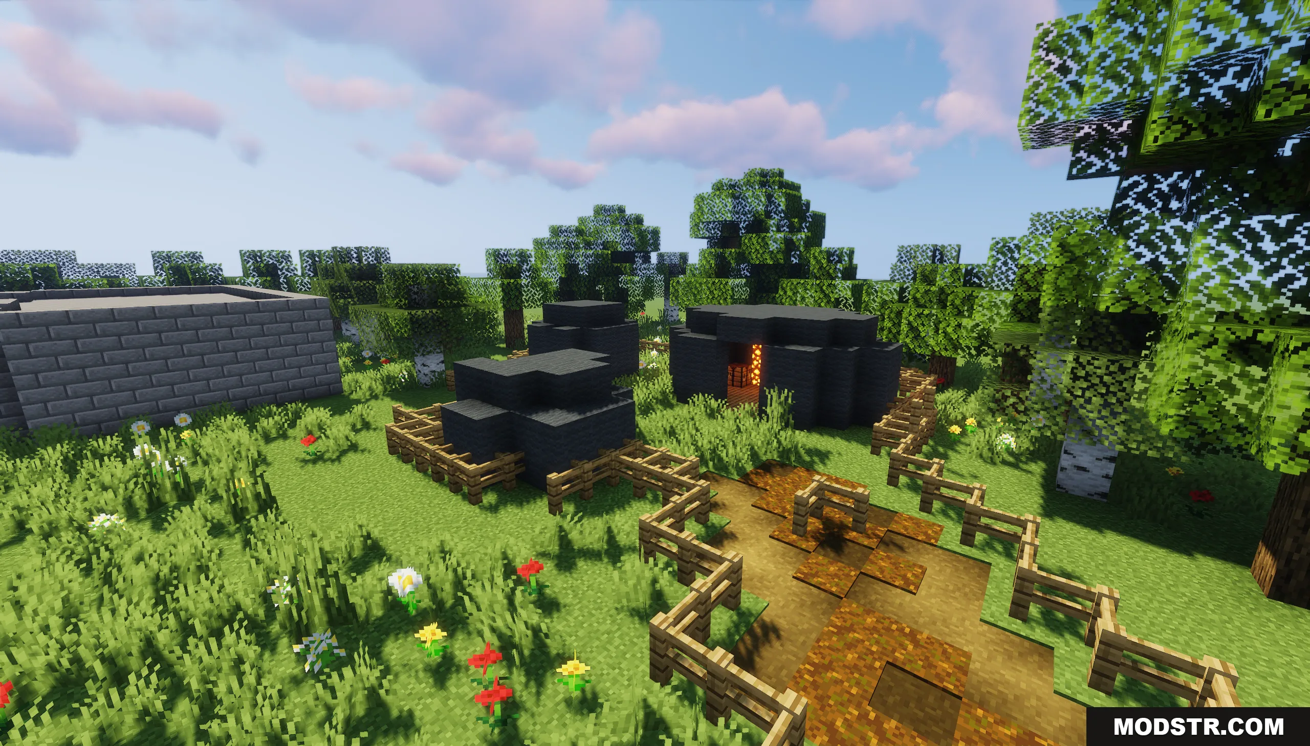The Town of Mordovia Map Screenshot 7 Small black circular huts and a stone building in a grassy field