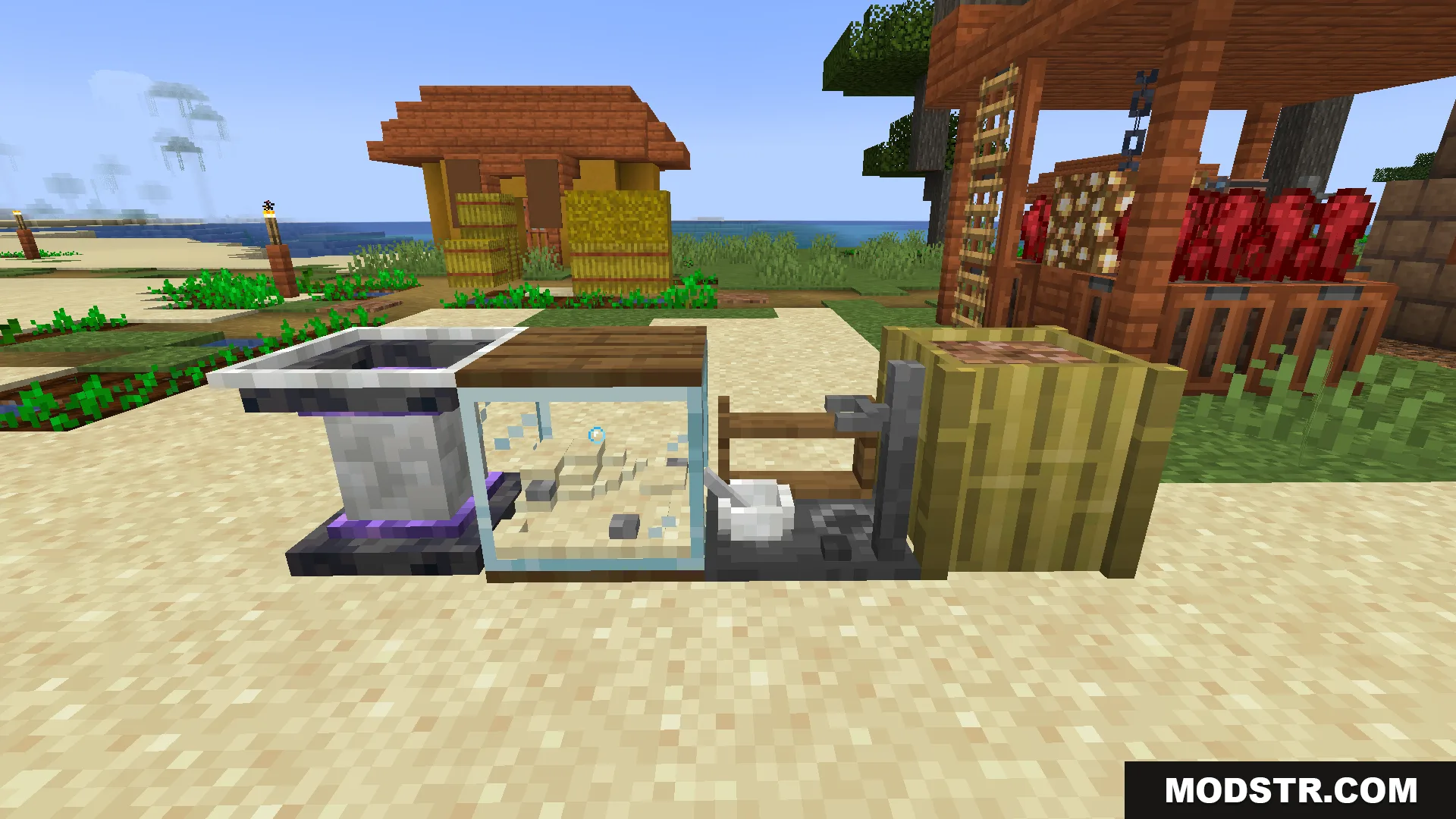Unique crafting stations and decorative blocks placed on sand near a village