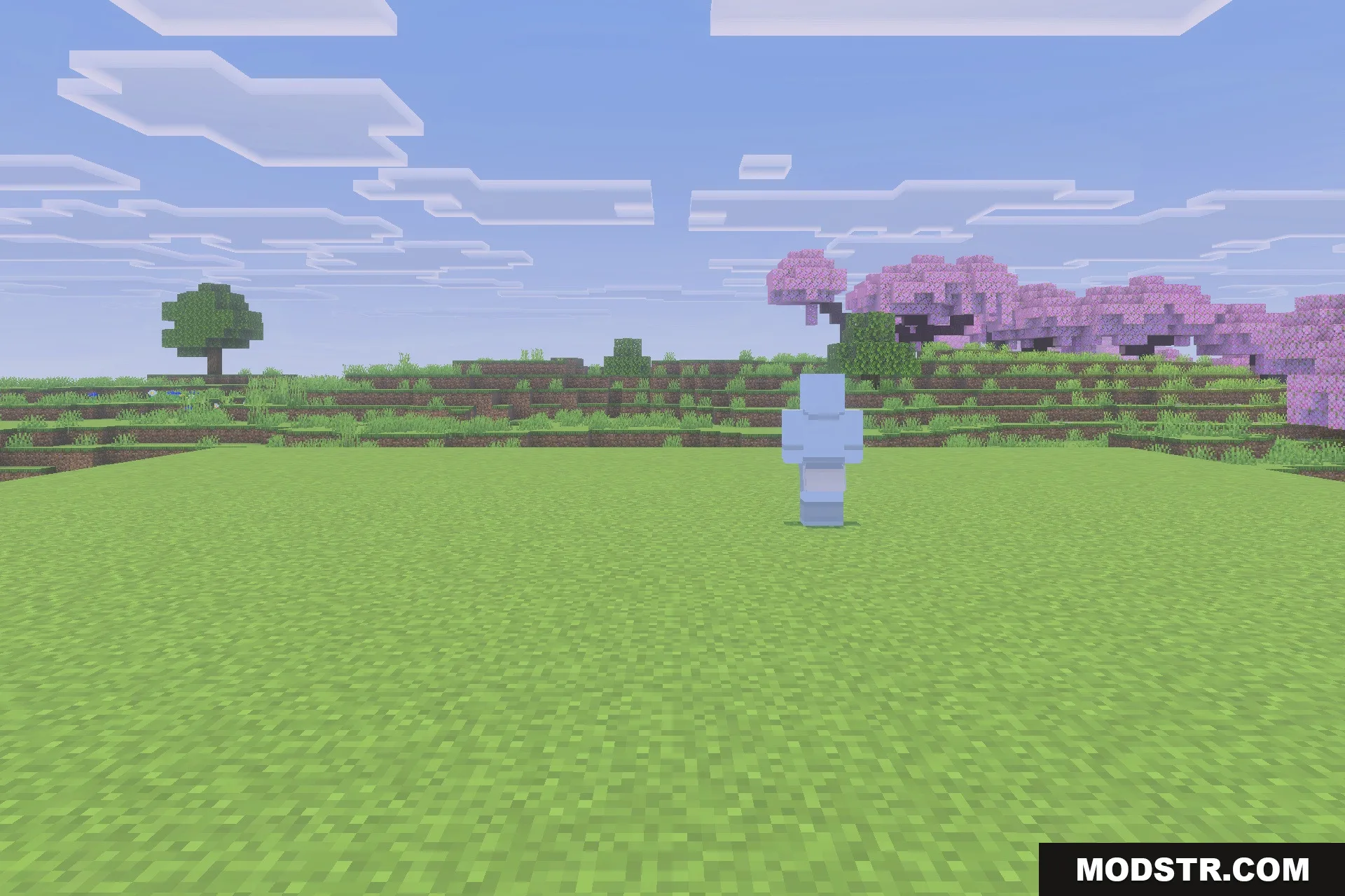 Viltrumite Addon Update Addon Screenshot 2 The transparent blue character model stands on a grassy field near pink trees