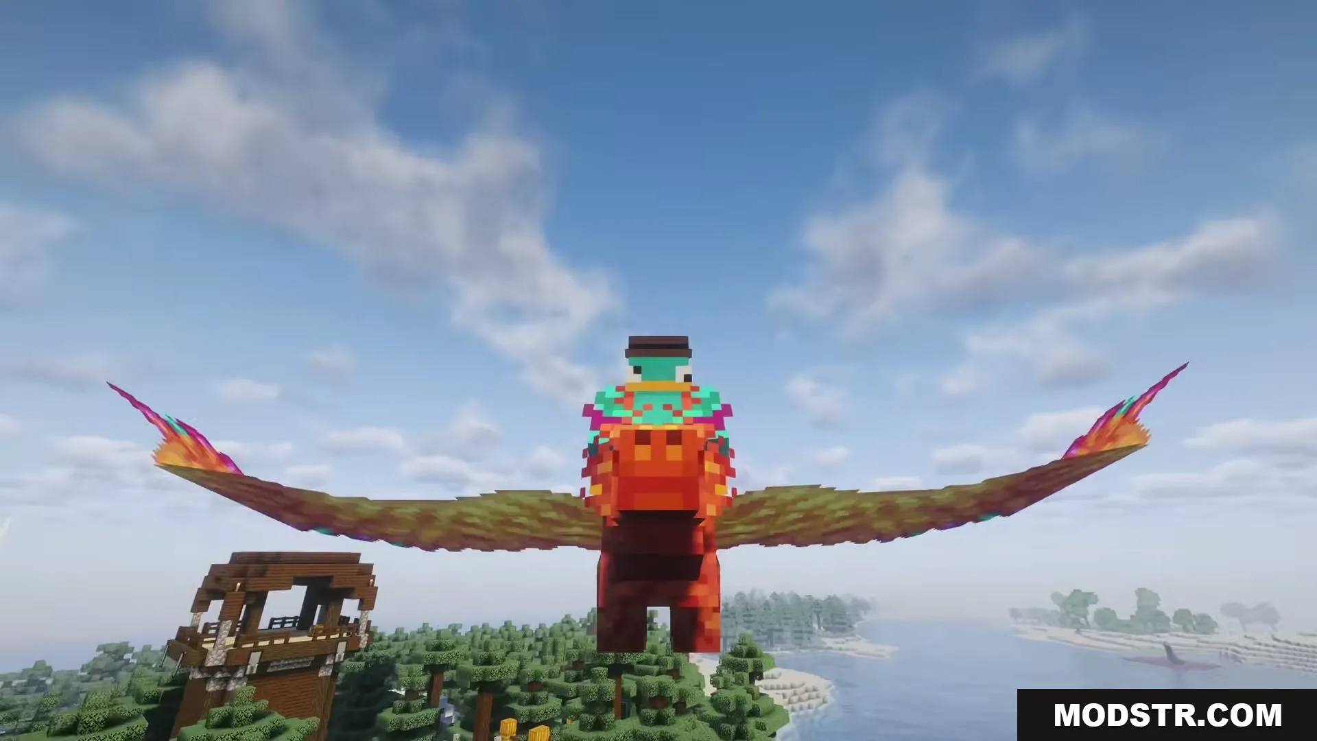 Wings of Fire by RipleysMods Mod Screenshot 1 A player riding a colorful phoenix mount above a pillager outpost in Minecraft